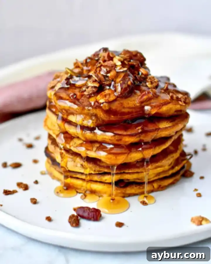 Fluffy Pumpkin Spice Pancakes 2 Harvest Pumpkin Crunch Pancakes stacked high with syrup and granola
