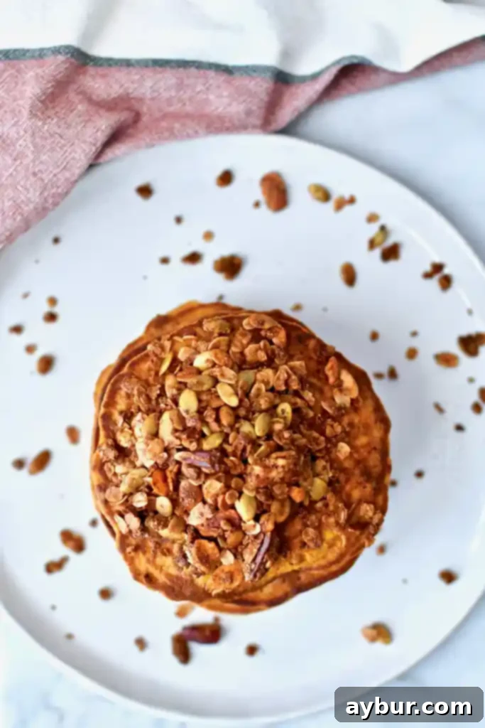 Fluffy Pumpkin Spice Pancakes 4 Close up of pumpkin crunch pancakes batter being poured onto griddle