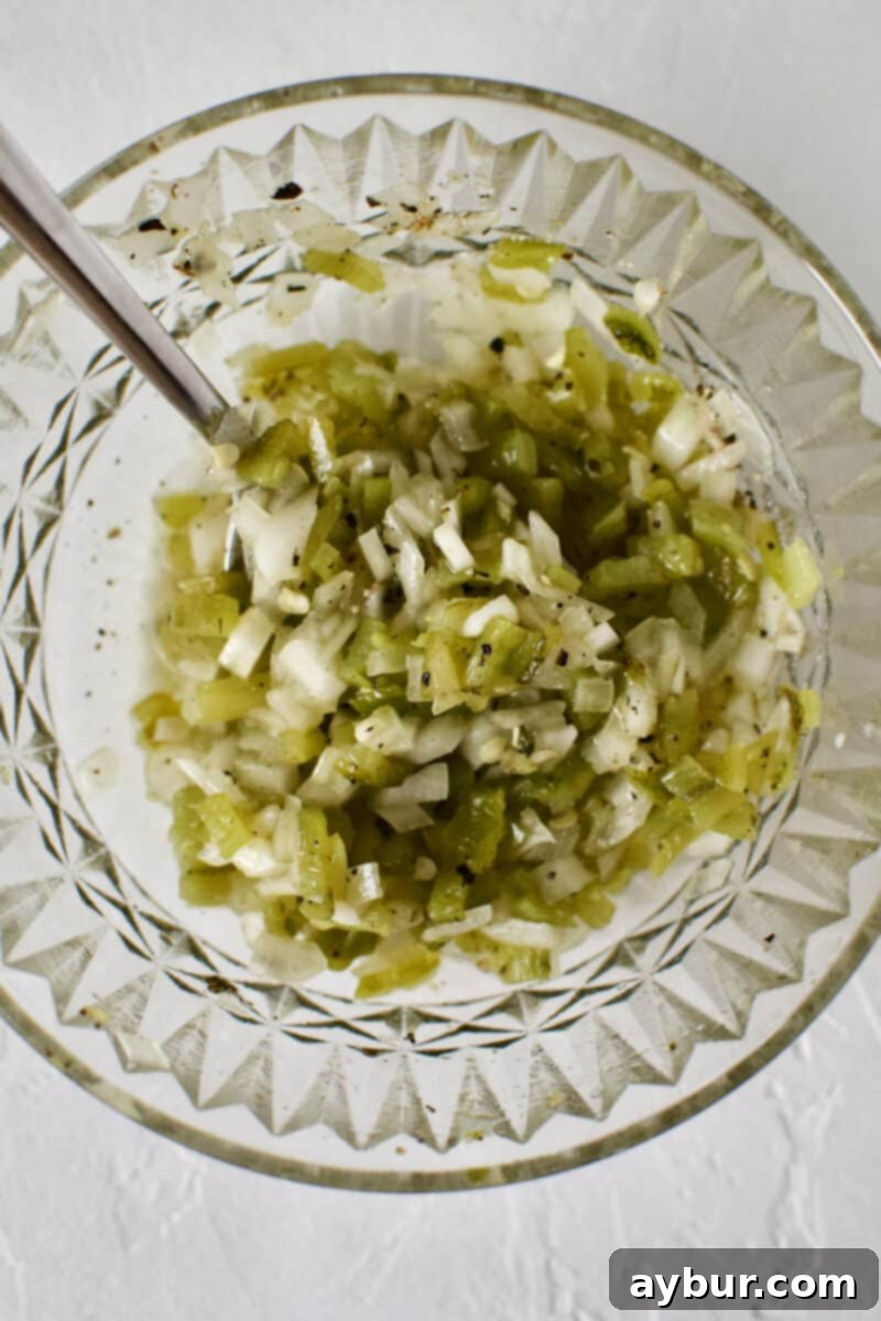 Quick Hatch Chile Salsa whipped up in a bowl, with diced chiles, onion, lime, and olive oil.