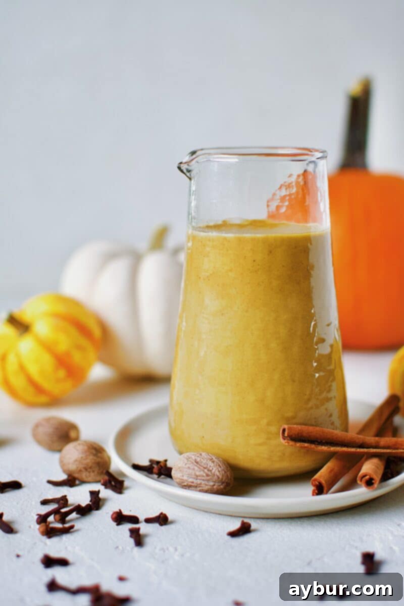 Sugar-Free Pumpkin Spice Syrup in a carafe ready for morning coffee to make a homemade Pumpkin Spice Latte.
