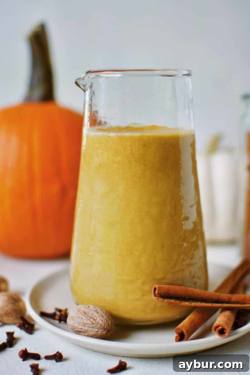Sugar-Free Pumpkin Spice Syrup in a carafe ready for morning coffee to make a homemade Pumpkin Spice Latte.