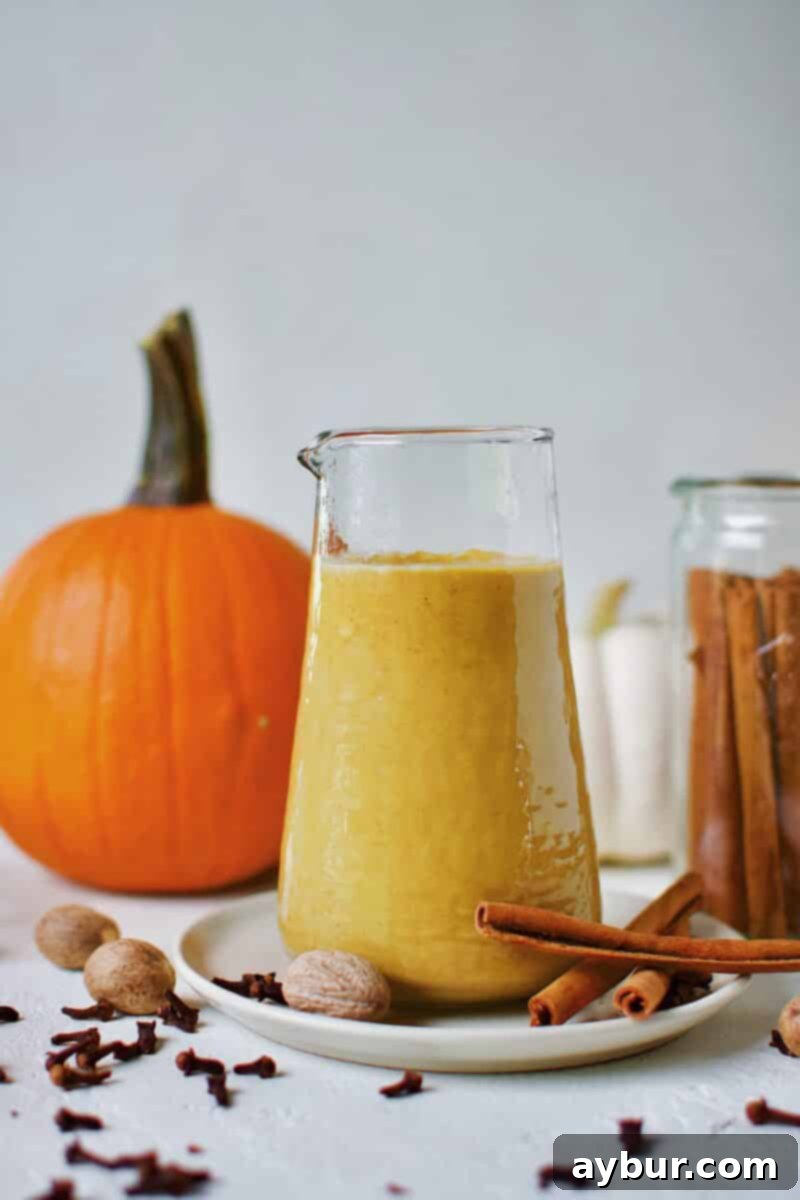 Sugar-Free Pumpkin Spice Syrup in a carafe ready for morning coffee to make a homemade Pumpkin Spice Latte.