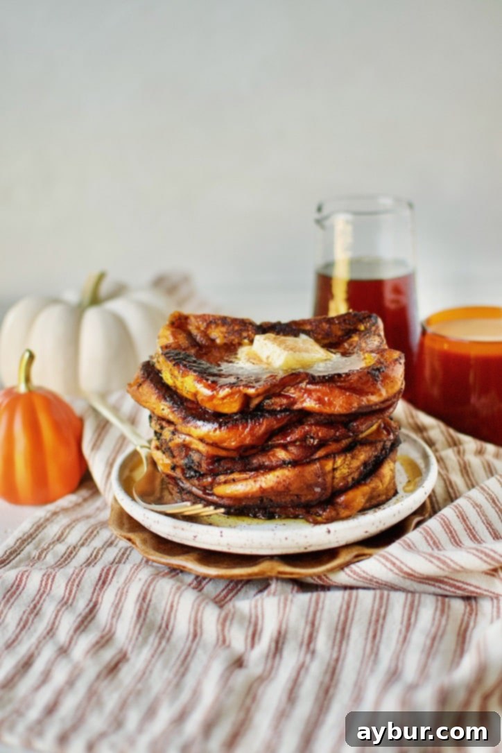 Pumpkin French Toast ready to eat topped with butter and pure maple syrup.