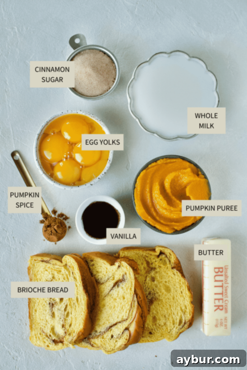 Ingredients needed to make Pumpkin French Toast, including brioche bread, egg yolks, pumpkin puree, milk, vanilla, cinnamon sugar, and pumpkin pie spice.