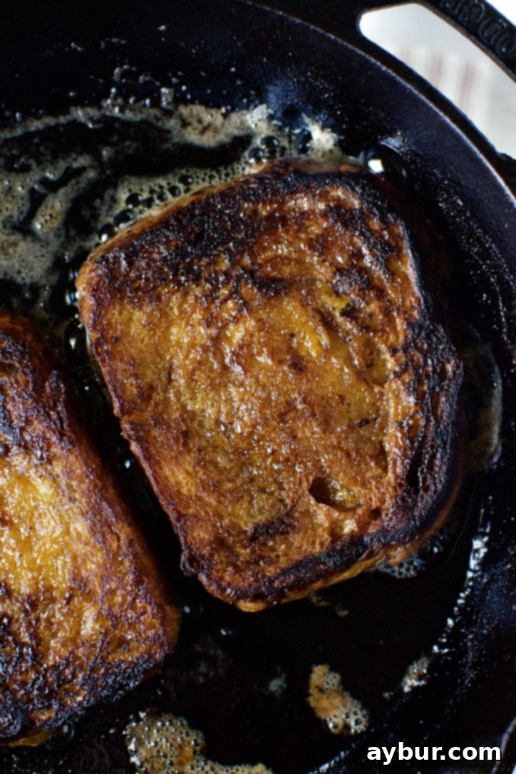 Finished Pumpkin French Toast, showcasing the rich, caramelized cinnamon sugar crust on both sides.