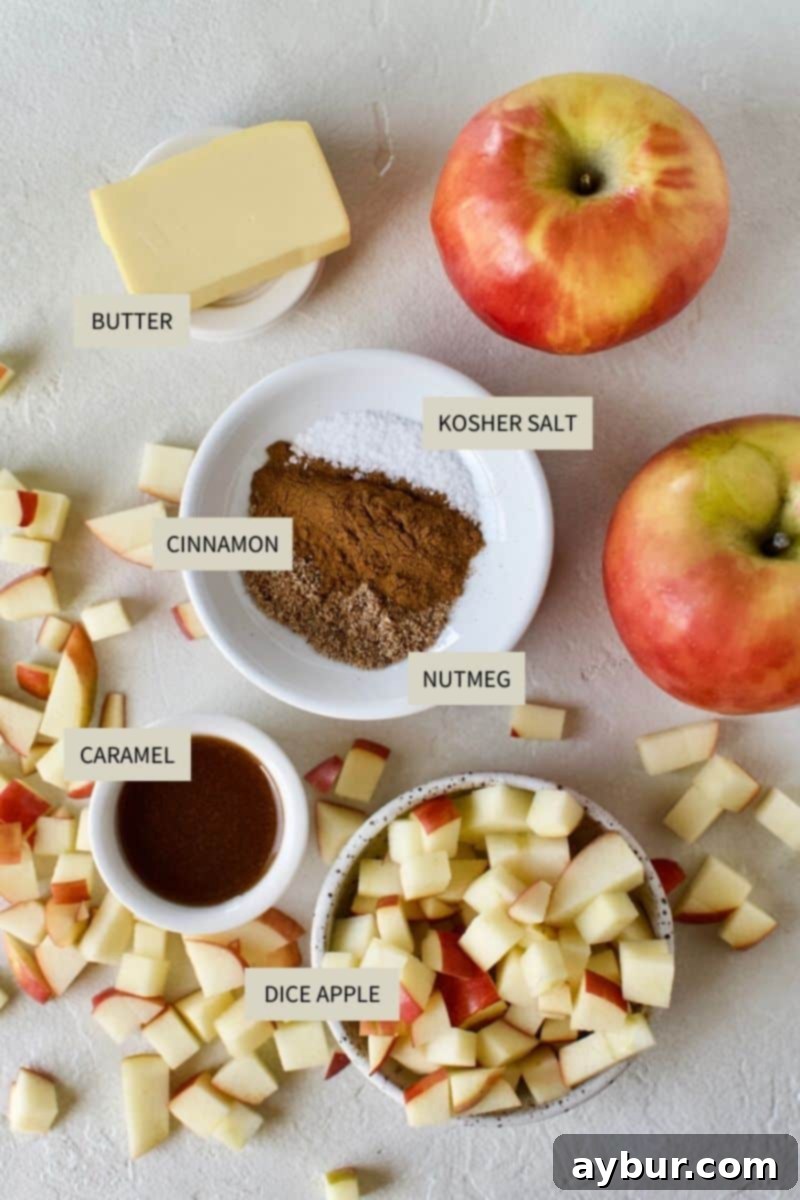 A selection of fresh ingredients including apples, butter, cinnamon, and nutmeg, neatly arranged for making Apple Hand Pies.
