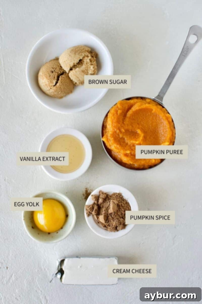 Pumpkin puree, cream cheese, brown sugar, and chai spice, laid out for Pumpkin Cheesecake Hand Pies.