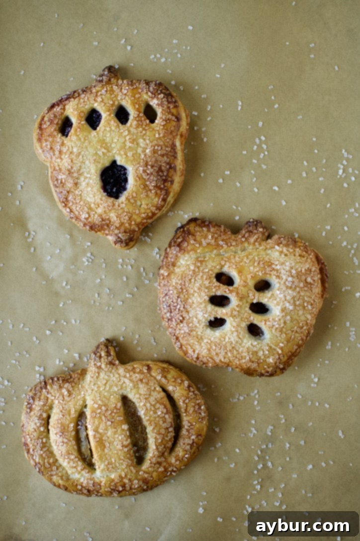 Freshly baked Apple Hand Pies, golden and crisp, cooling on a rack right out of the oven.