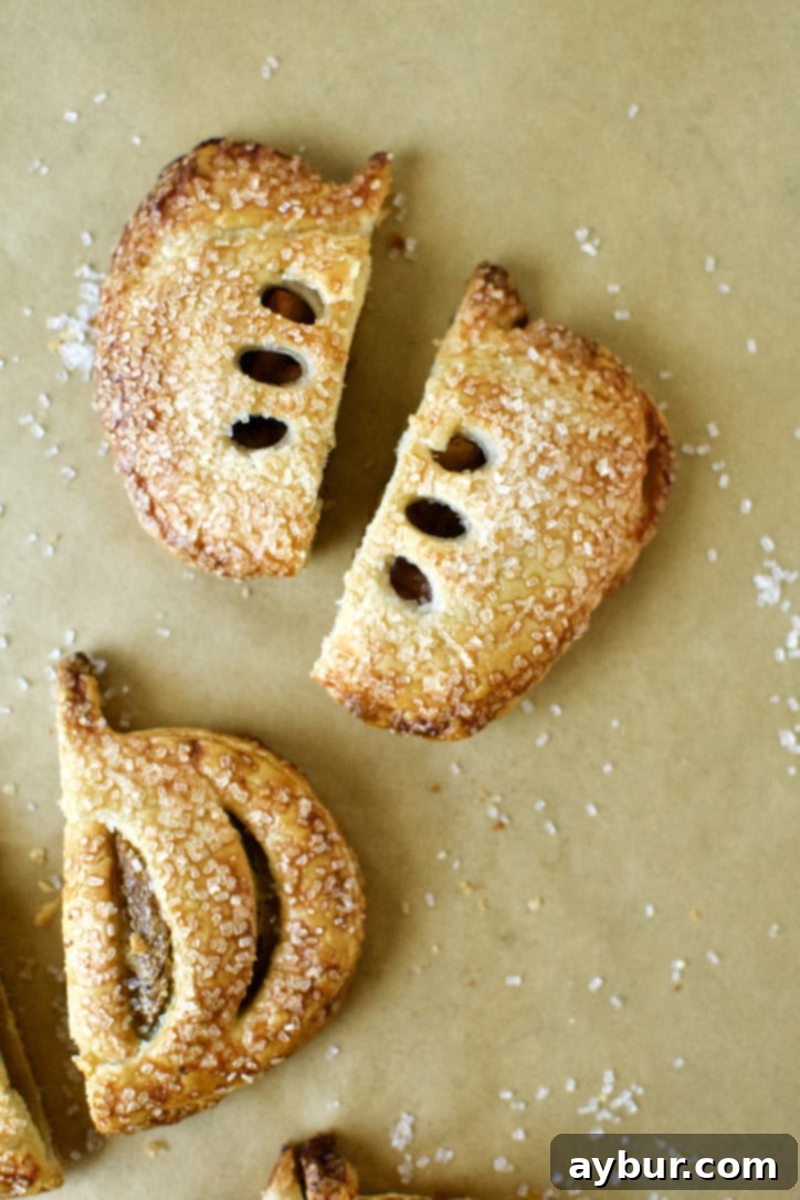 A freshly baked Caramel Apple Hand Pie, sliced in half to reveal the rich, gooey filling and tender apple chunks.