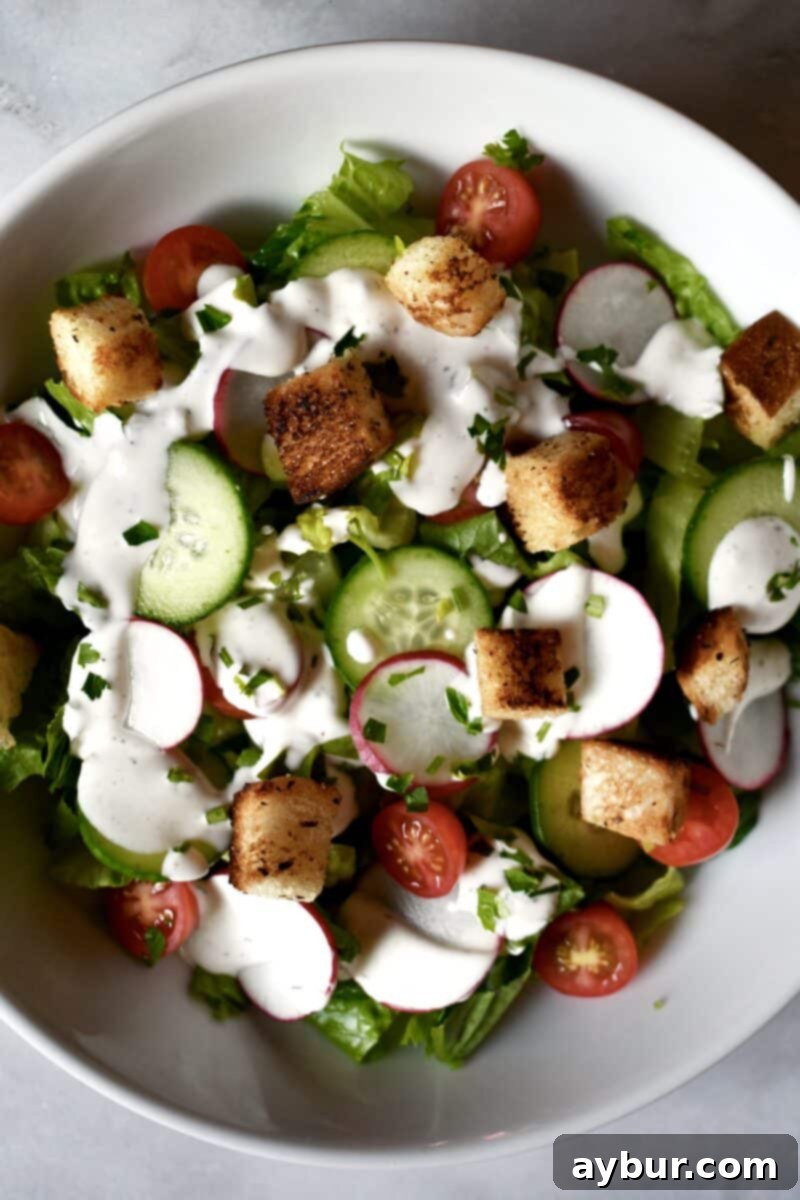 Freshly prepared Romaine Salad with Buttermilk Ranch Dressing and golden skillet croutons, ready to be served.