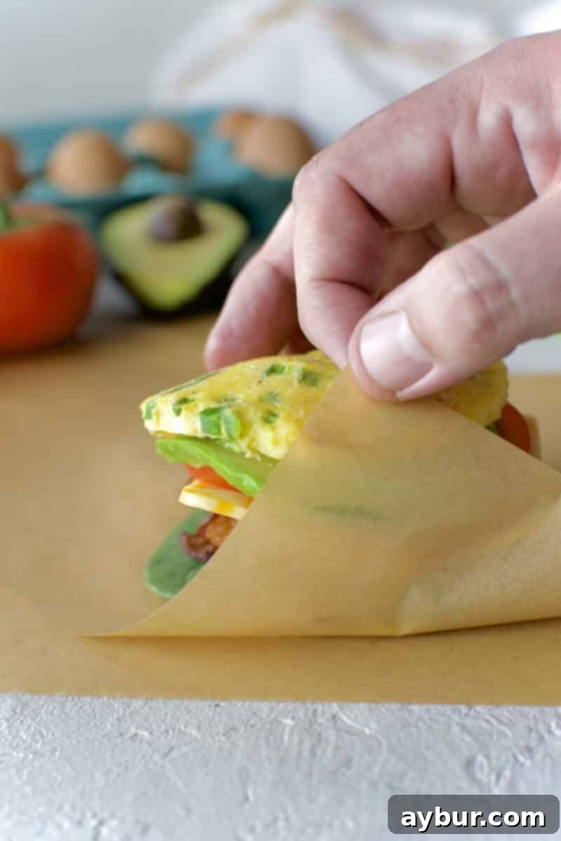Wholesome Breakfast Sandwich 19 Folding the parchment paper around the eggwich.