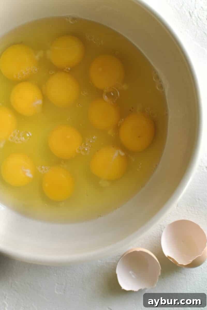 Wholesome Breakfast Sandwich 4 Step-by-step image of eggs being whisked in a bowl.