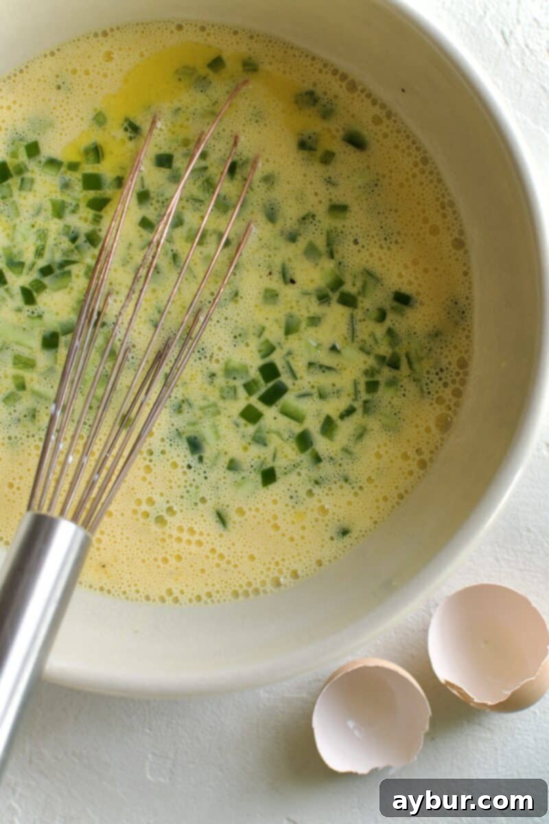 Wholesome Breakfast Sandwich 7 Adding diced jalapenos to the egg mixture for flavor and texture.