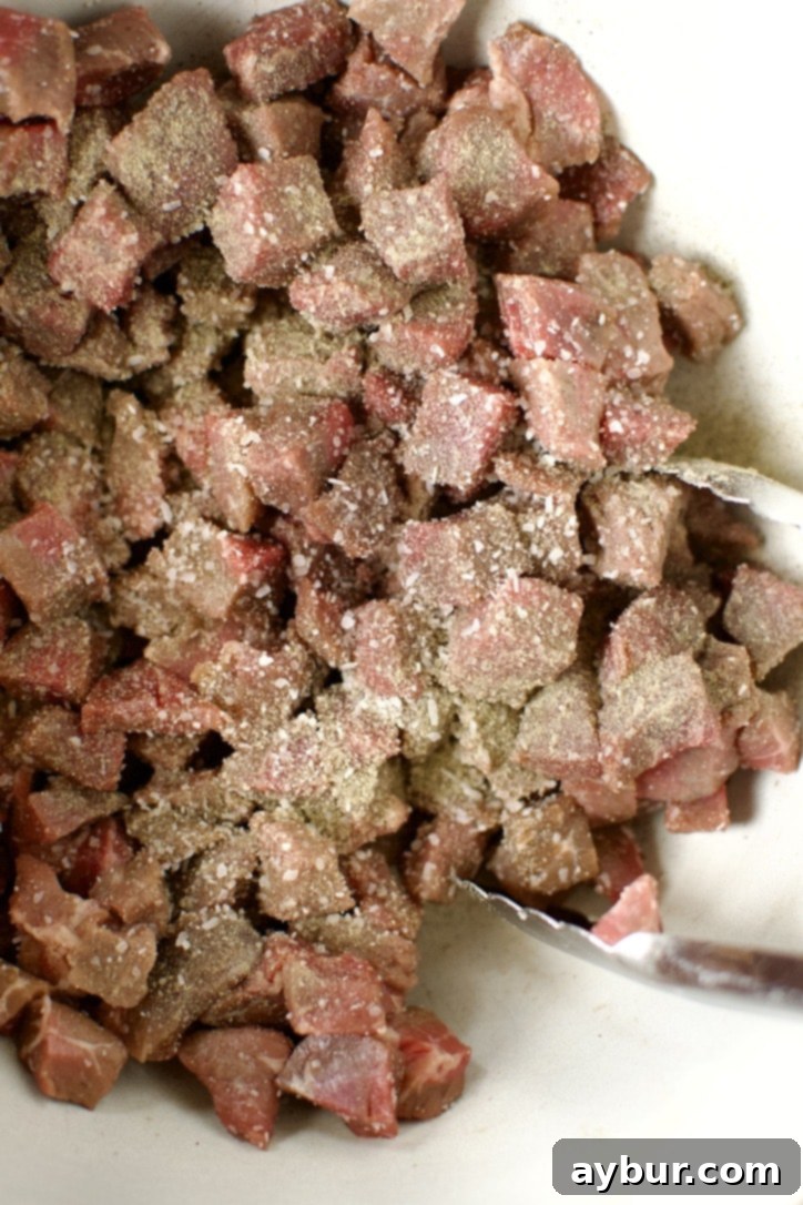 Beef Pot Pie 4 Diced stew beef generously seasoned with coarse salt and fresh black pepper, ready for the next step.