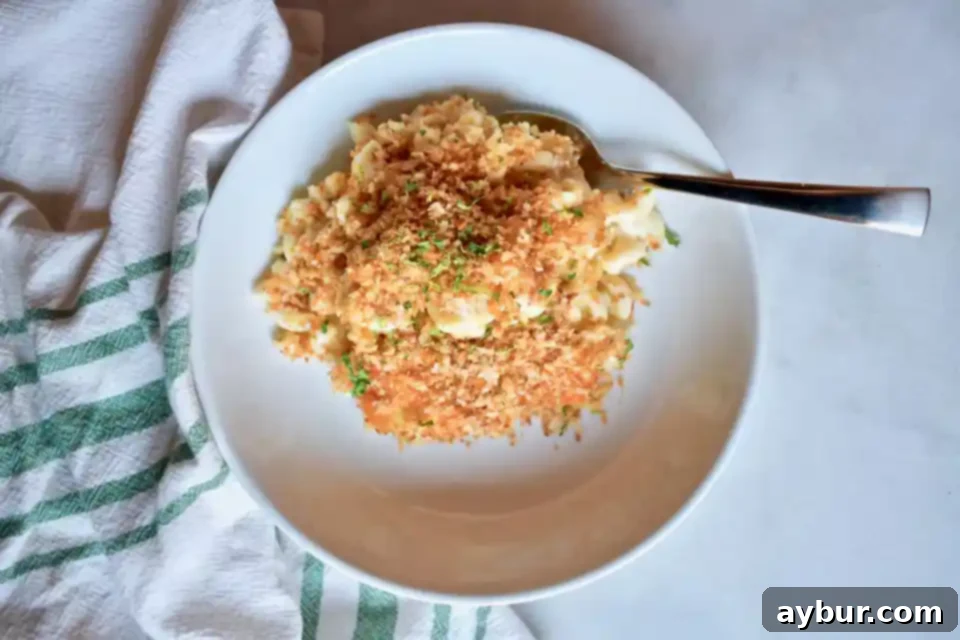 A large baking dish filled with Joanna Gaines' creamy mac and cheese, featuring a golden, crispy Panko and garlic topping.