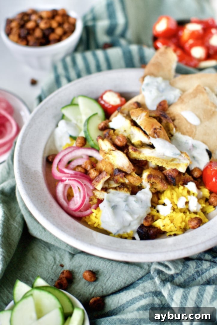 A beautifully assembled Chicken Shawarma bowl, ready to be enjoyed, showcasing tender chicken, fresh vegetables, and creamy sauce.