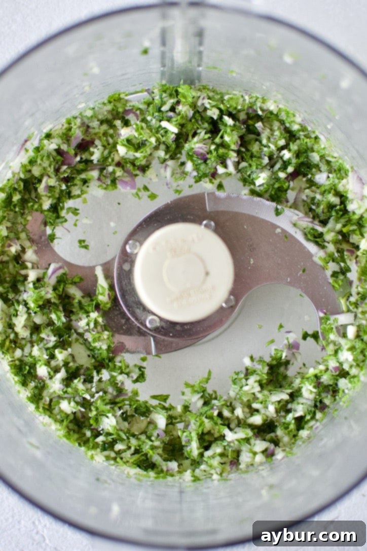 Finely blended parsley, garlic, and red onion in a food processor, ready for the shrimp.