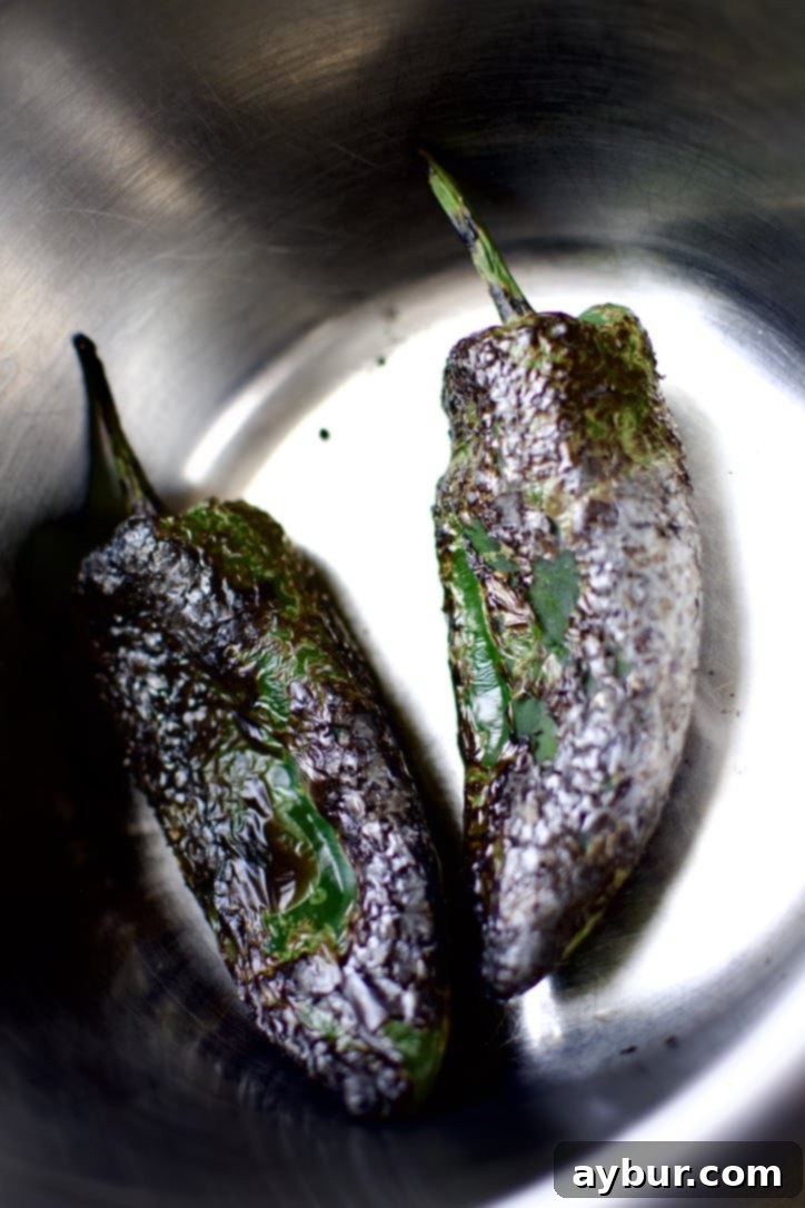 Smoky Sweet Corn and Pepper Salsa 5 A bowl of freshly blistered Poblano peppers, skins blackened and ready for steaming and peeling.