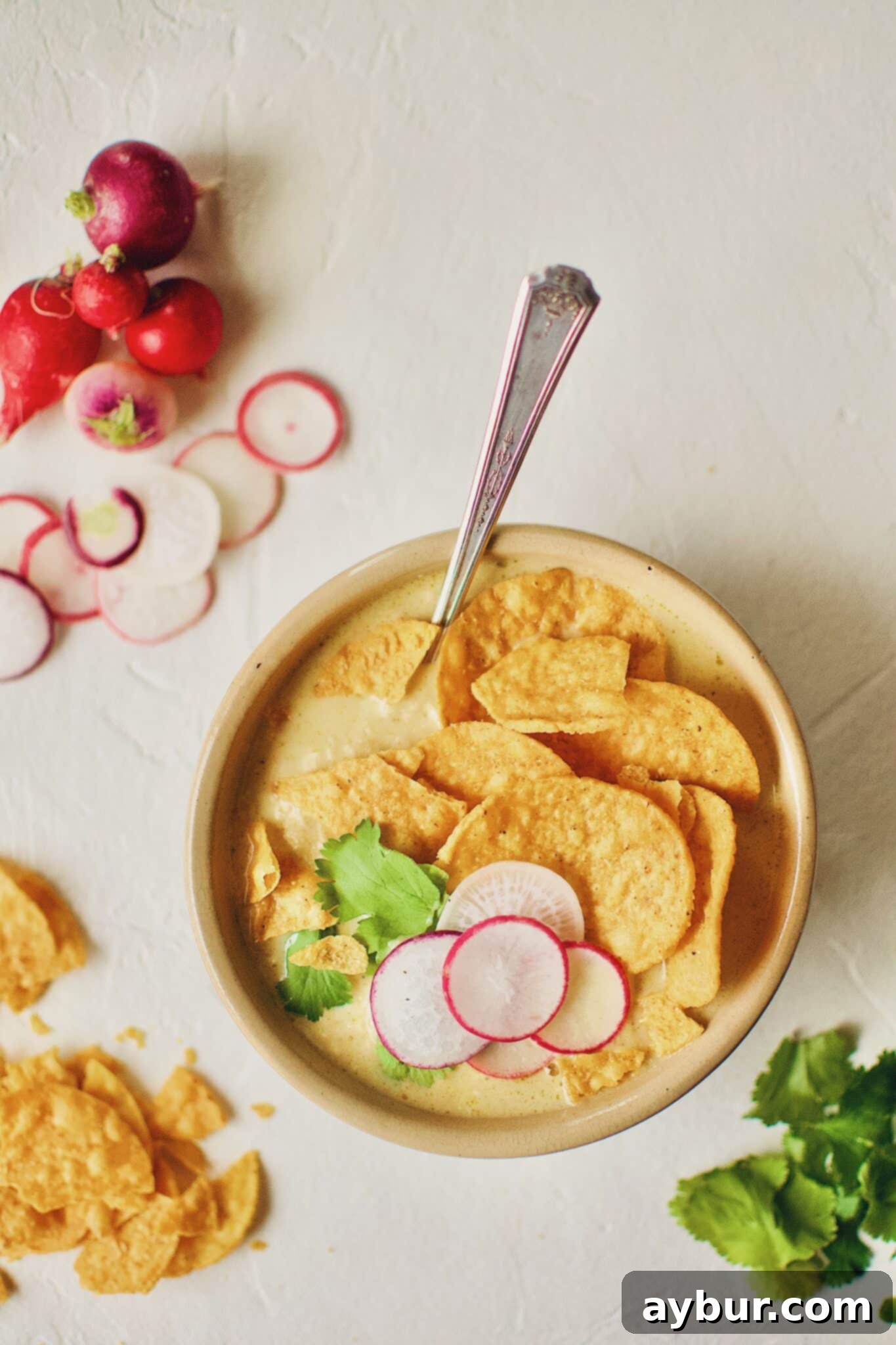 Joanna Gaines Creamy Chicken Poblano Soup in a rustic bowl, garnished beautifully, prepared by KendellKreations.com.