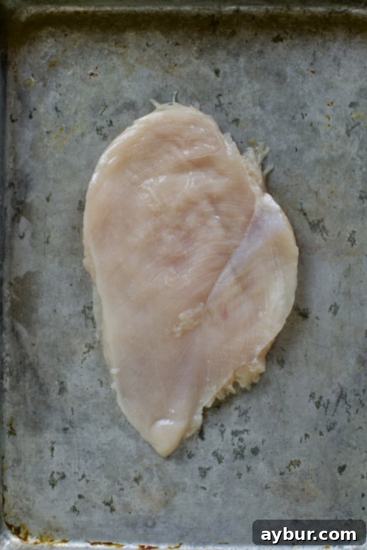 Mediterranean Lemon Orzo Chicken 4 Chicken breast on a sheet pan.