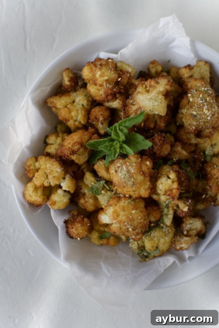 Golden Olive Oil Cauliflower 6 Fried Cauliflower in Olive Oil in a bowl ready to eat. Garnished with Greek seasoning and oregano.