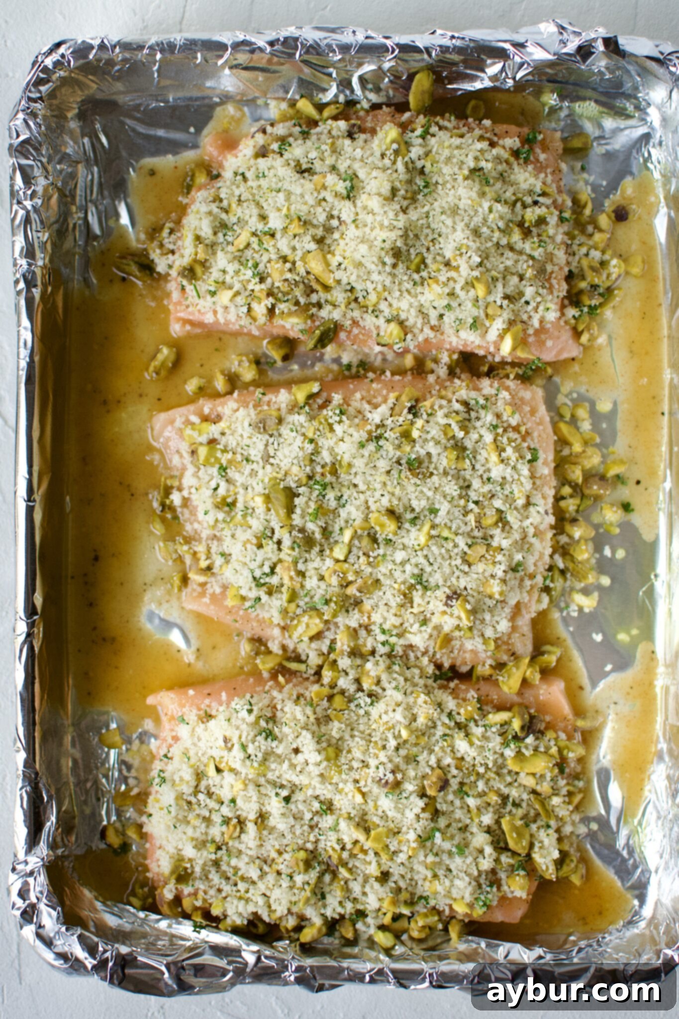 Crisp Pistachio Salmon 6 Salmon fillets topped with the pistachio crust ready to be baked.