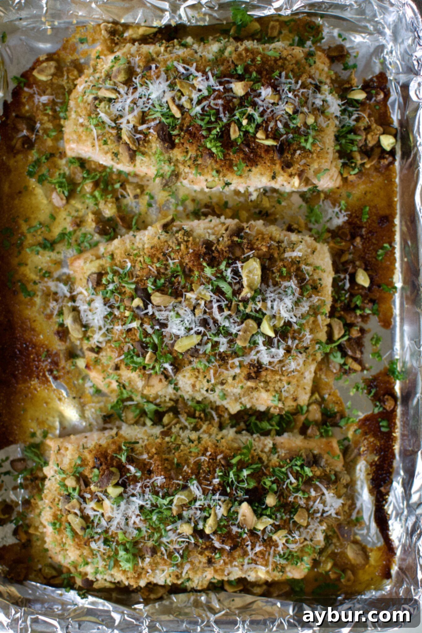 Crisp Pistachio Salmon 7 Pistachio Crusted Salmon fresh out of the oven, topped with parsley and parmesan.