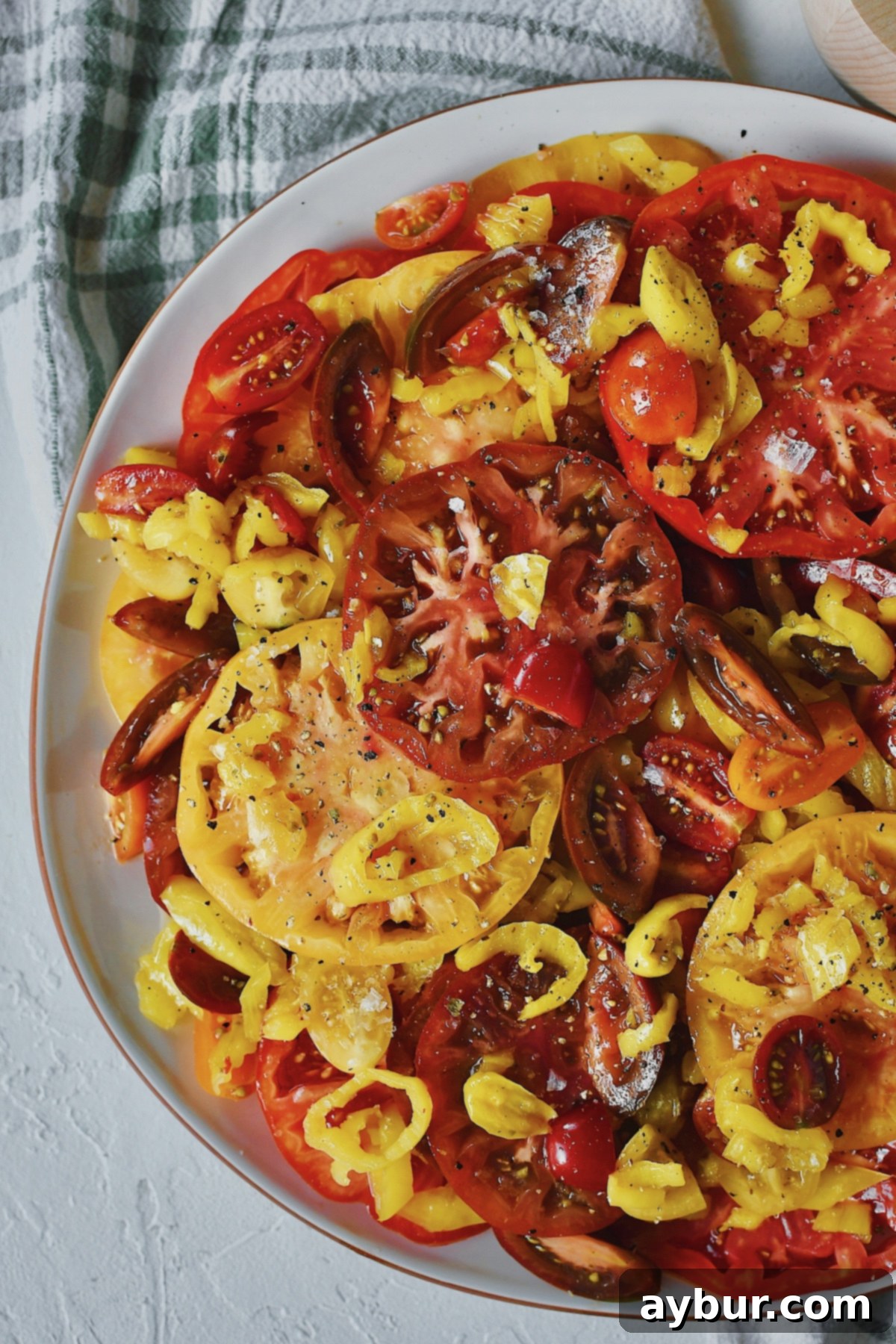 Creamy Burrata and Zesty Banana Pepper Tomato Salad 9 Heirloom tomatoes, topped with marinated banana peppers and grape tomatoes.