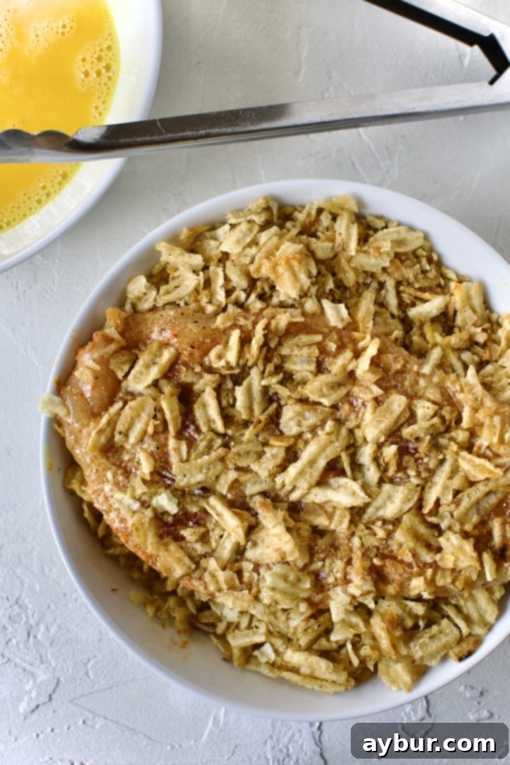 Chip-Crusted Chicken 7 dredging the chicken in crushed potato chips.