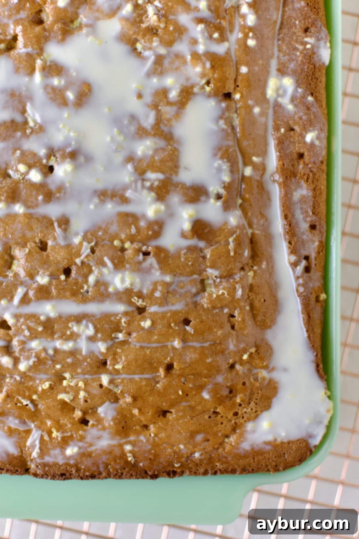 Effortless Tres Leches Cake 9 Tres Leches cake generously soaked with the milk mixture, visibly absorbing the liquid.