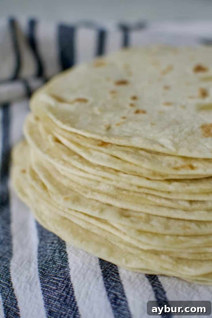 Easy Homemade Flour Tortillas cooked and ready to eat, stacked for serving.