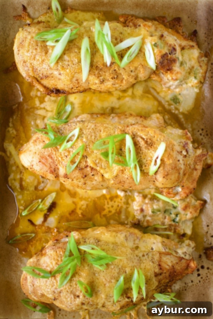 Jalapeño Popper Stuffed Chicken 14 Stuffed Chicken Breast with Cheese after initial baking, twine removed and topped with cheese, after broiling.