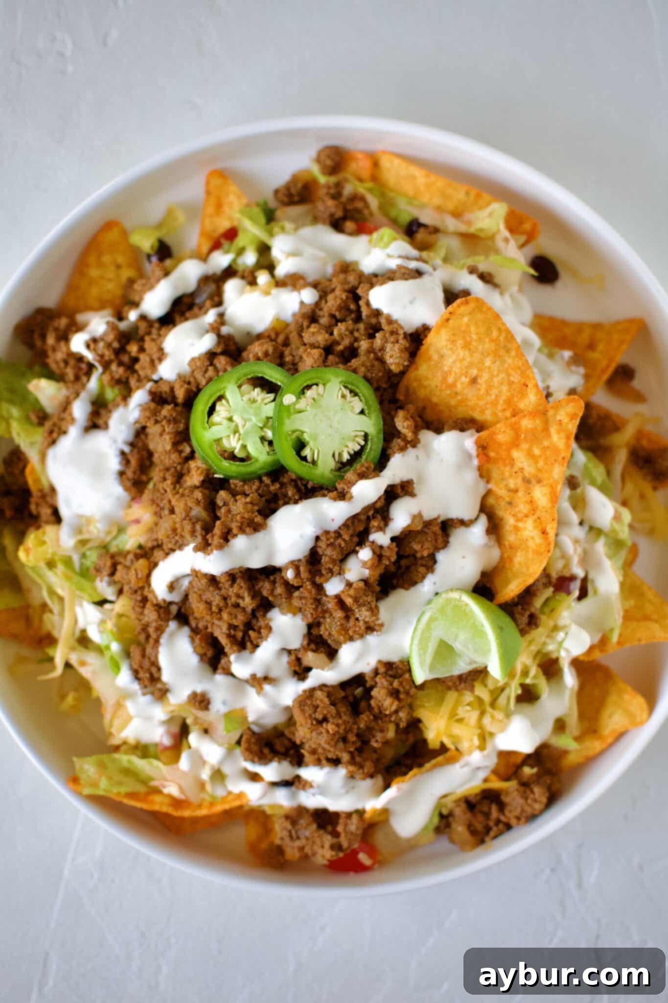 A large, vibrant Doritos Taco Salad on a plate, ready to be enjoyed.