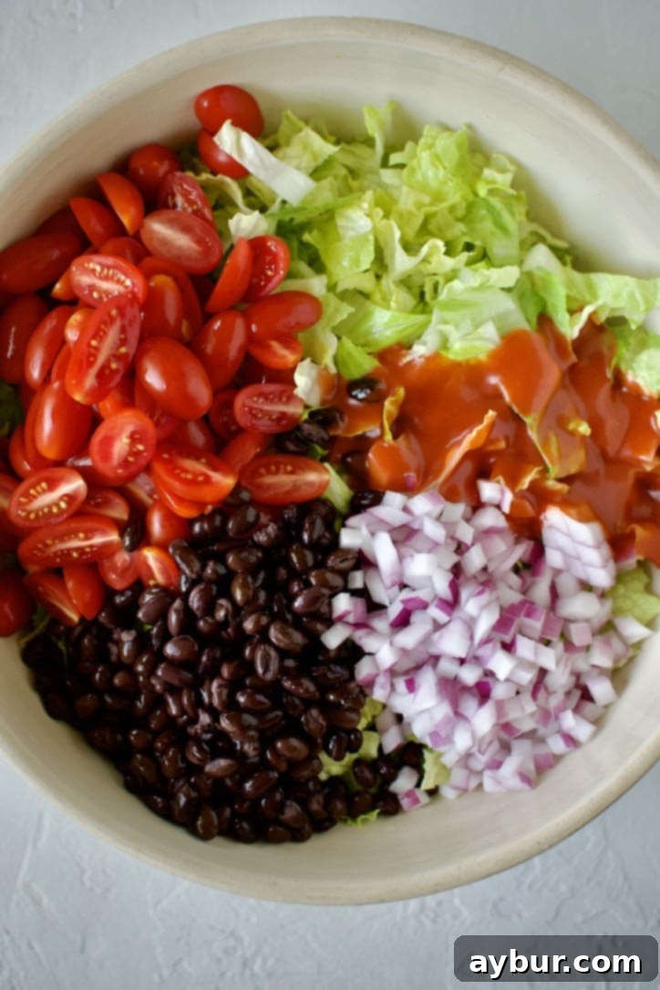 Ground beef being cooked and seasoned in a skillet for taco salad.