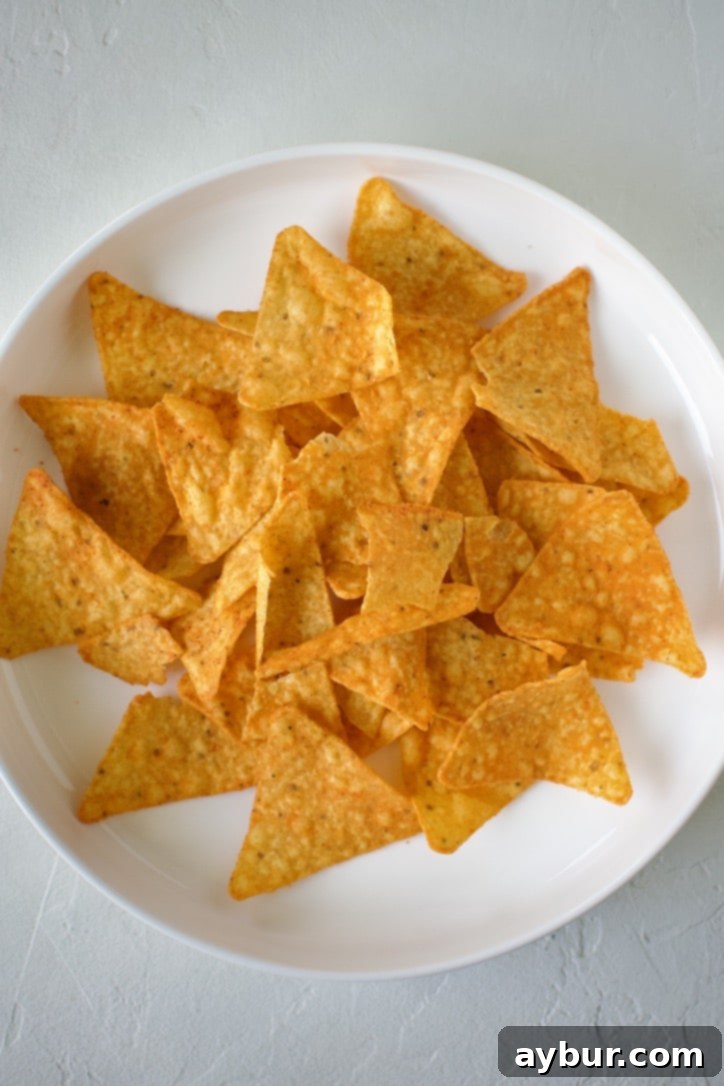 Doritos chips laid out on a plate, forming the base for a taco salad.