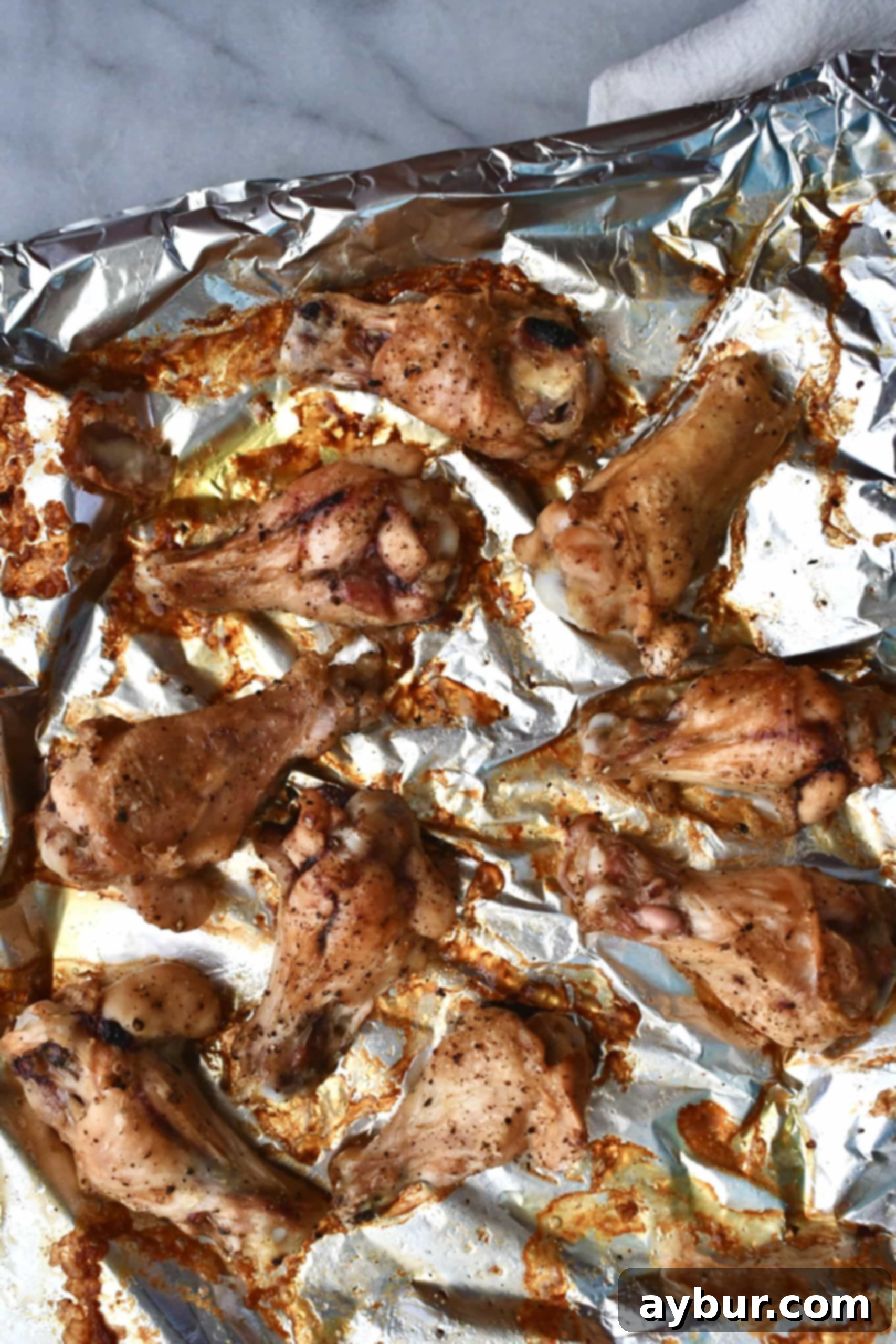 A close-up shot of perfectly golden-brown, crispy chicken wings fresh out of the oven, demonstrating ideal baking results.