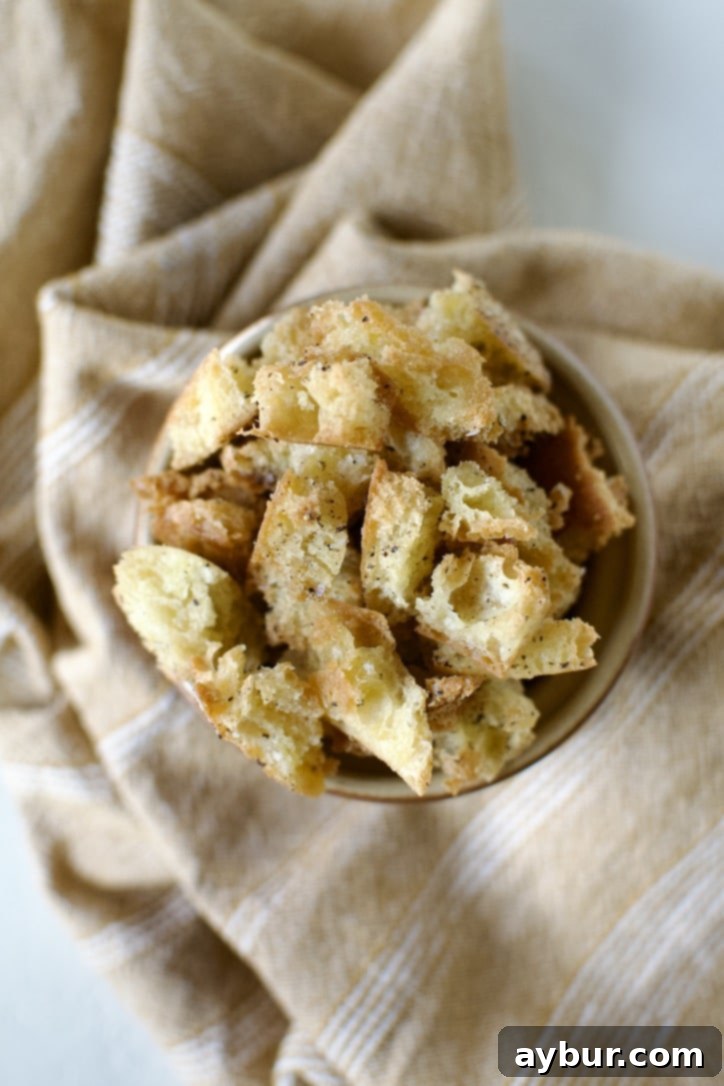 Traditional Caesar Salad 9 A close-up shot of a creamy Caesar dressing being drizzled over freshly shaved Parmesan cheese, highlighting the rich texture of the dressing.