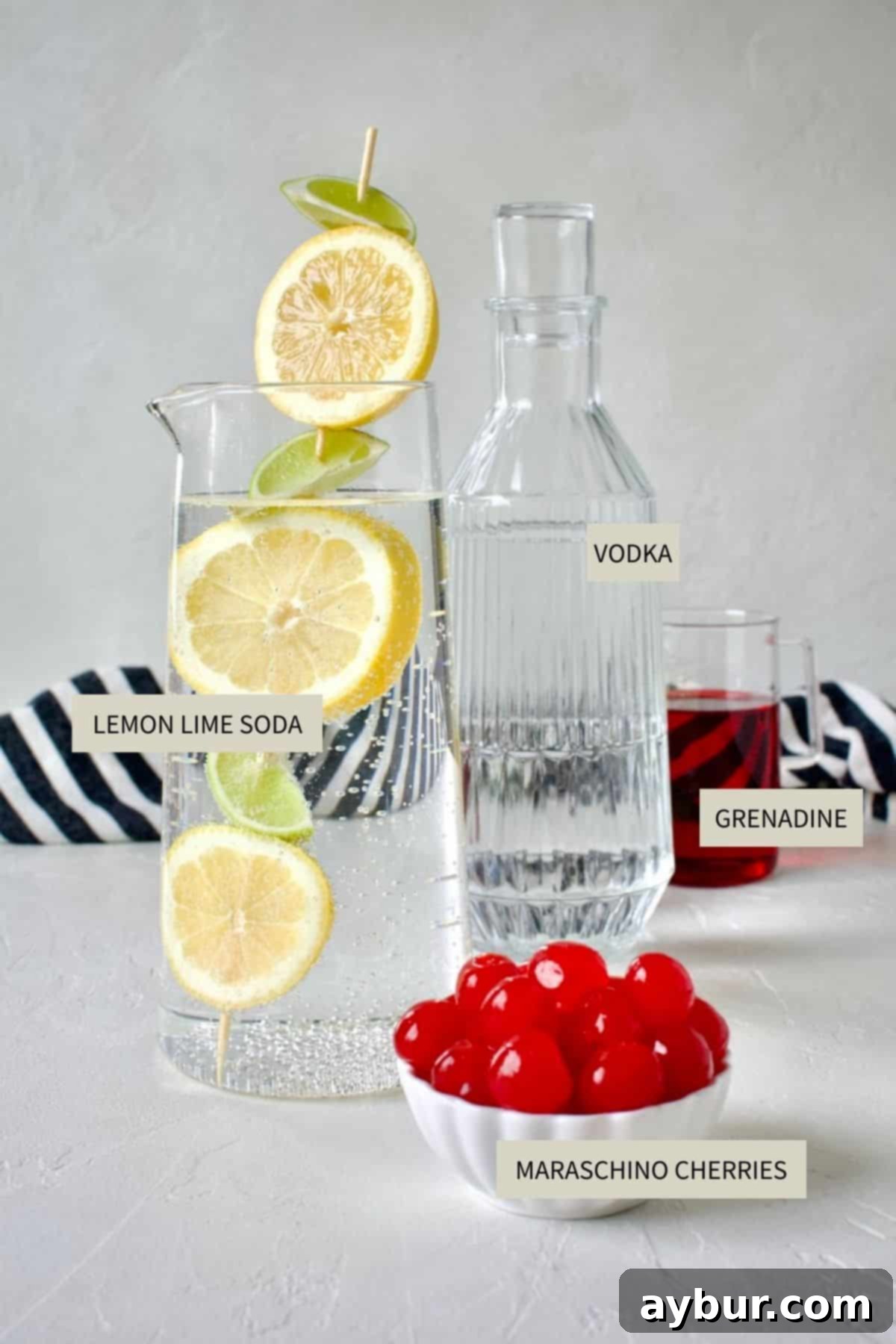 Shirley Temple Classic Mocktail 3 All ingredients needed to make a Shirley Temple Cocktail laid out on a table.