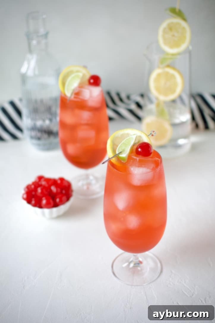 Shirley Temple Classic Mocktail 4 Shirley Temple Cocktail being poured over ice in a glass.