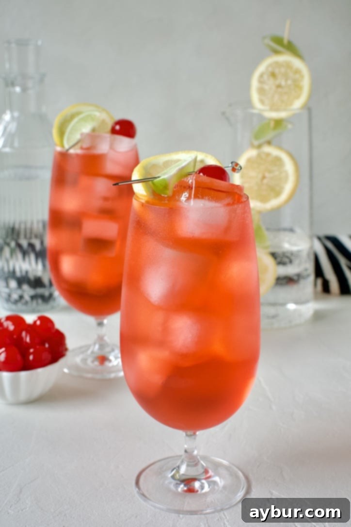 Shirley Temple Classic Mocktail 5 Close-up of a Shirley Temple Cocktail ready to drink, showing the cherry and citrus garnish.
