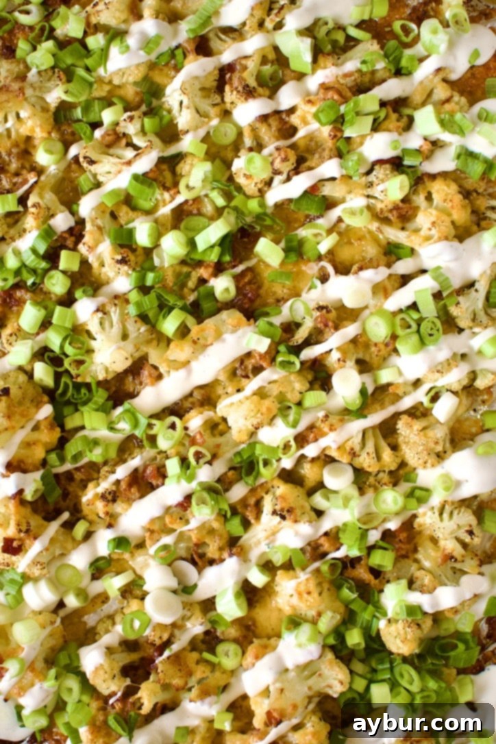 Loaded Baked Cauliflower with ranch drizzle and green onions.