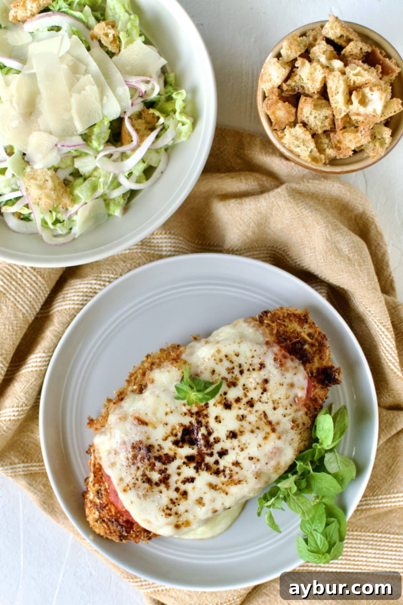 A perfectly baked chicken parmesan serving with golden crust and melted cheese.