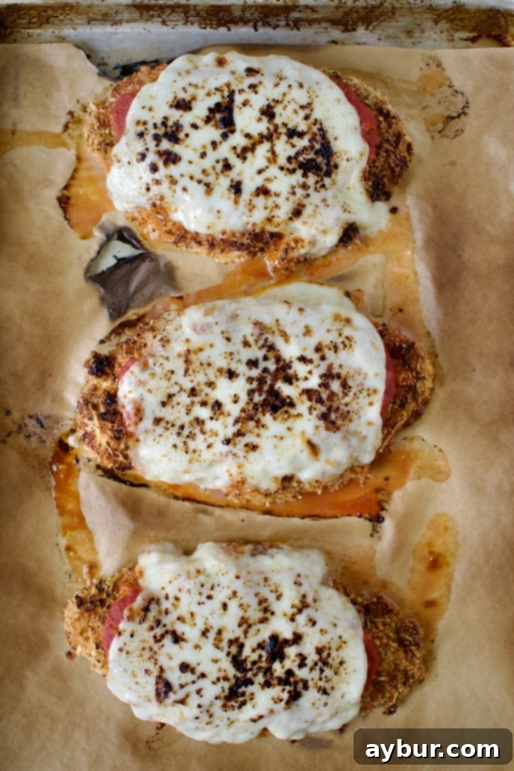 Perfectly broiled chicken parmesan with melted, bubbly cheese.