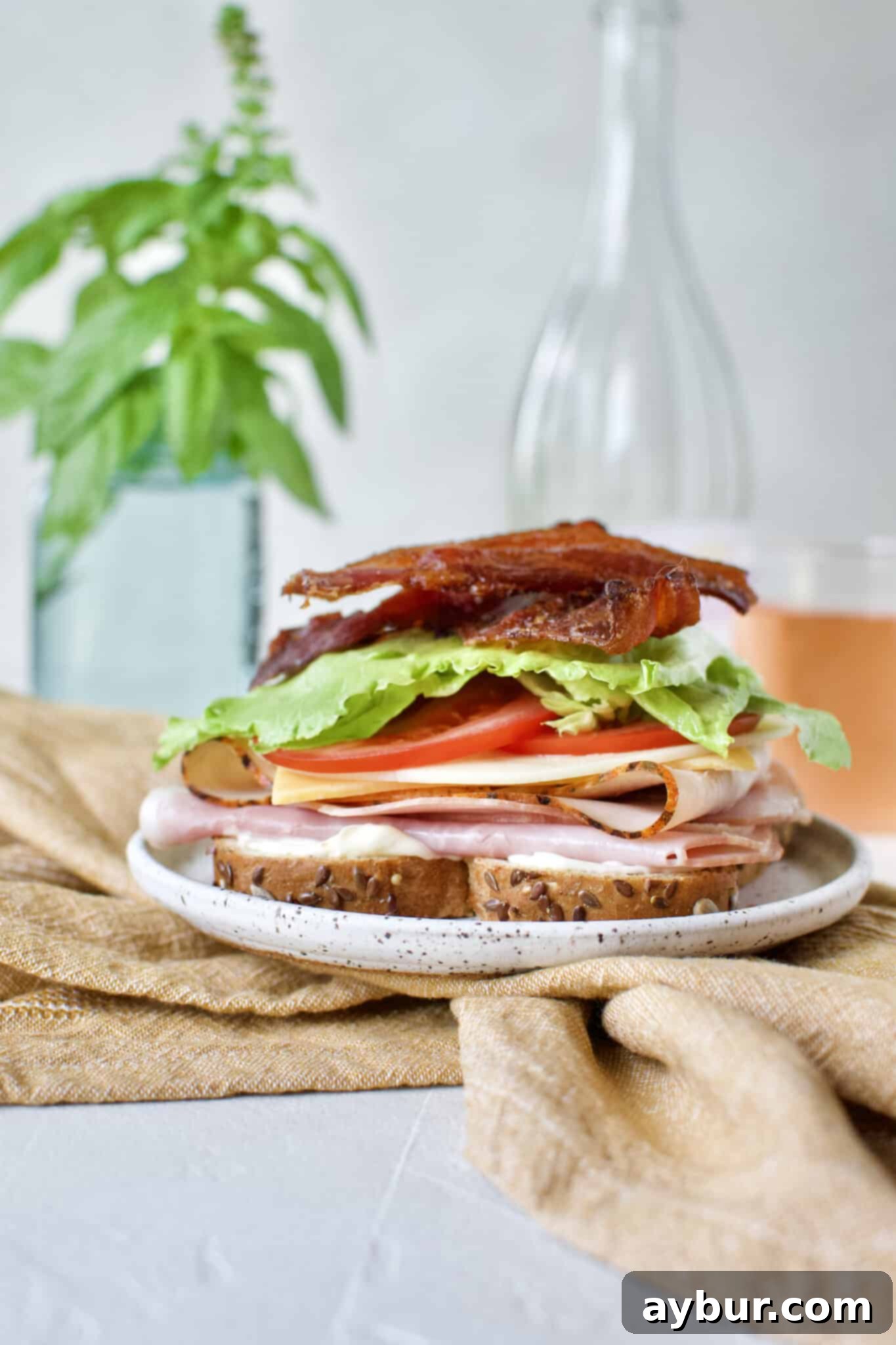 Crunchy, perfectly cooked bacon strips are placed on the Club Sandwich, adding a smoky, salty flavor.