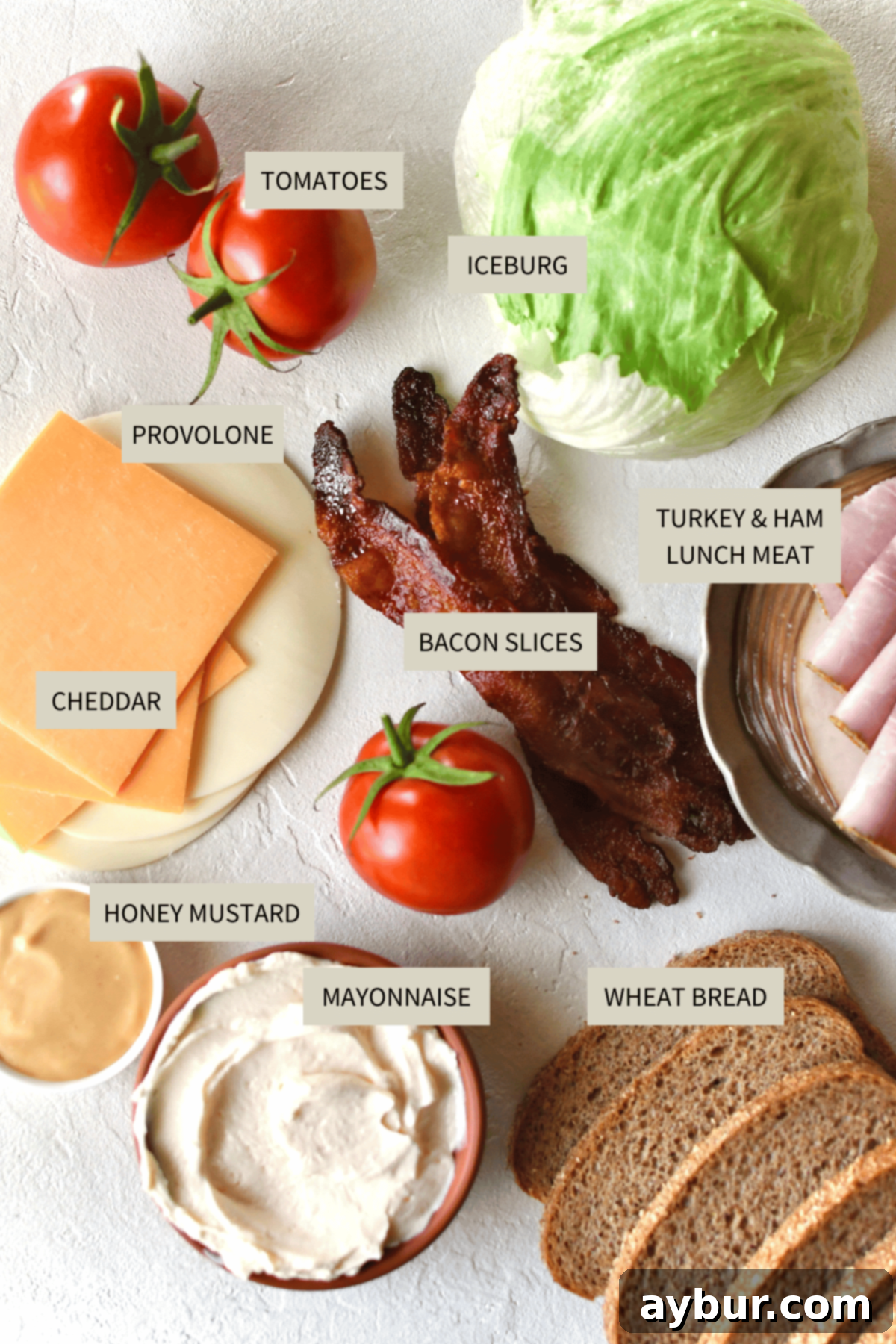A vibrant selection of fresh ingredients laid out, ready to be assembled into a delicious Club Sandwich, including bread, deli meats, cheeses, tomato, lettuce, and sauces.