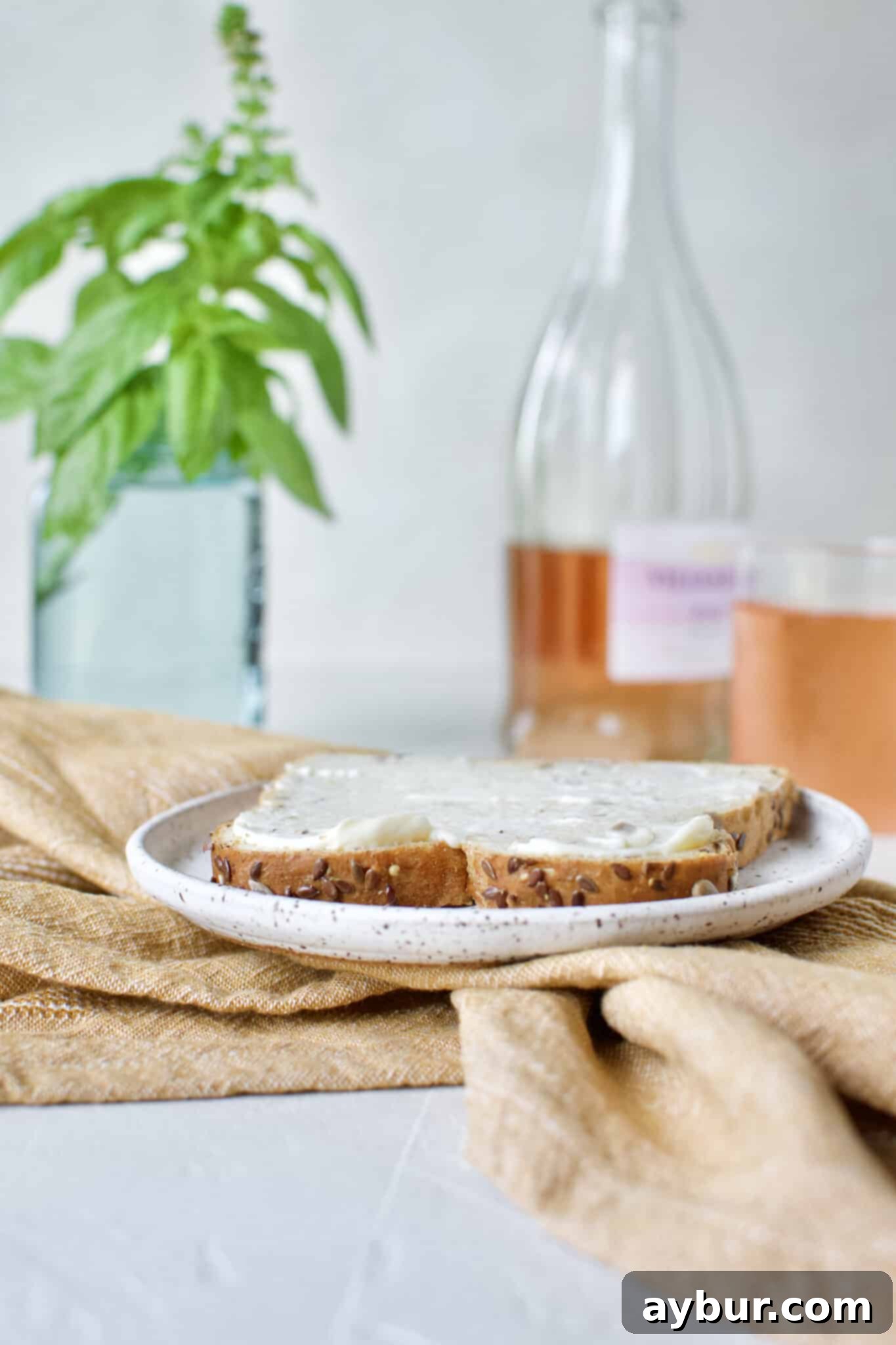 Applying a generous layer of creamy mayonnaise to the first slice of bread, setting the foundation for the Club Sandwich.
