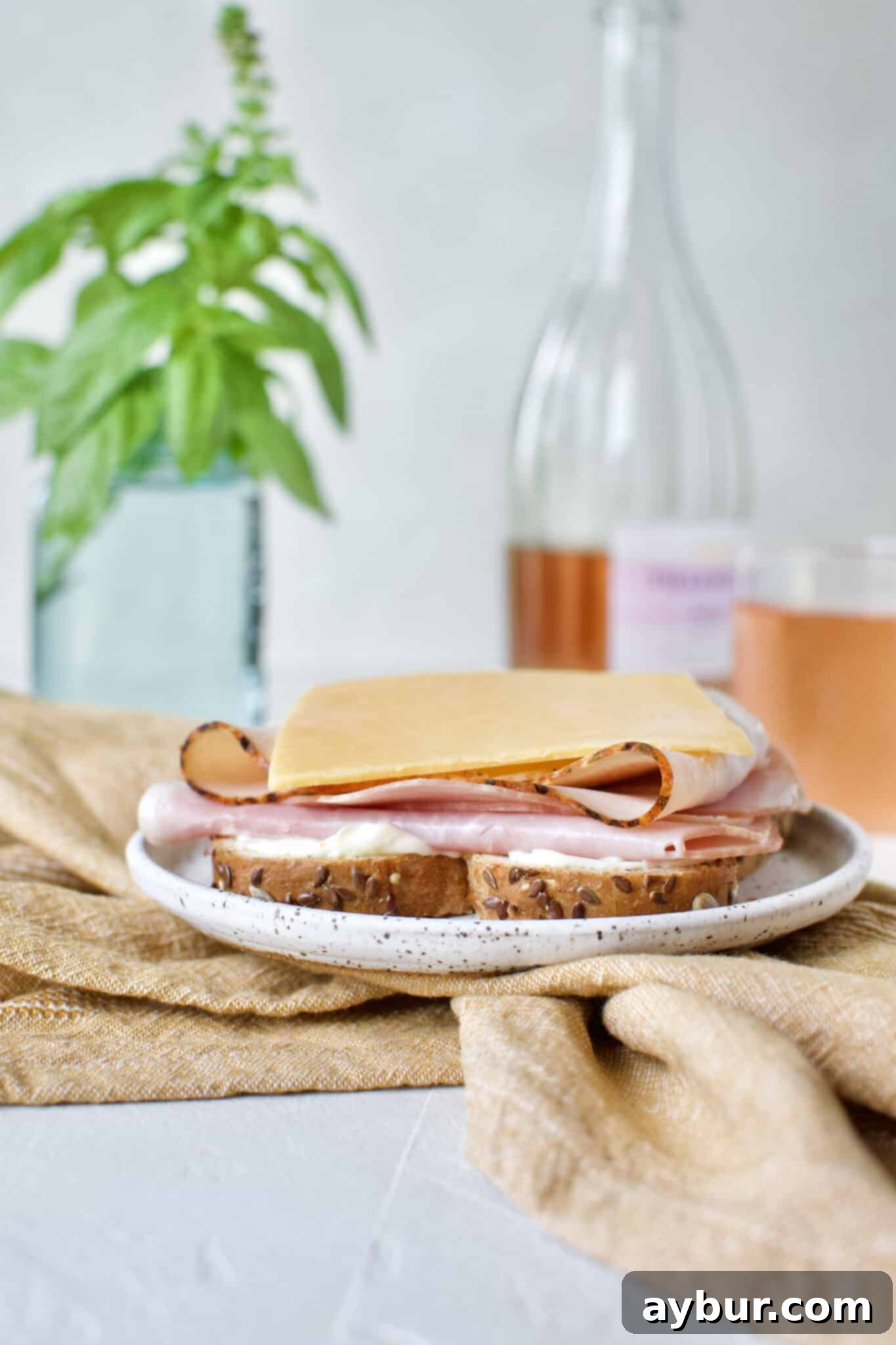 Next layer for the Club Sandwich includes a slice of rich cheddar cheese, building up the flavor profile.