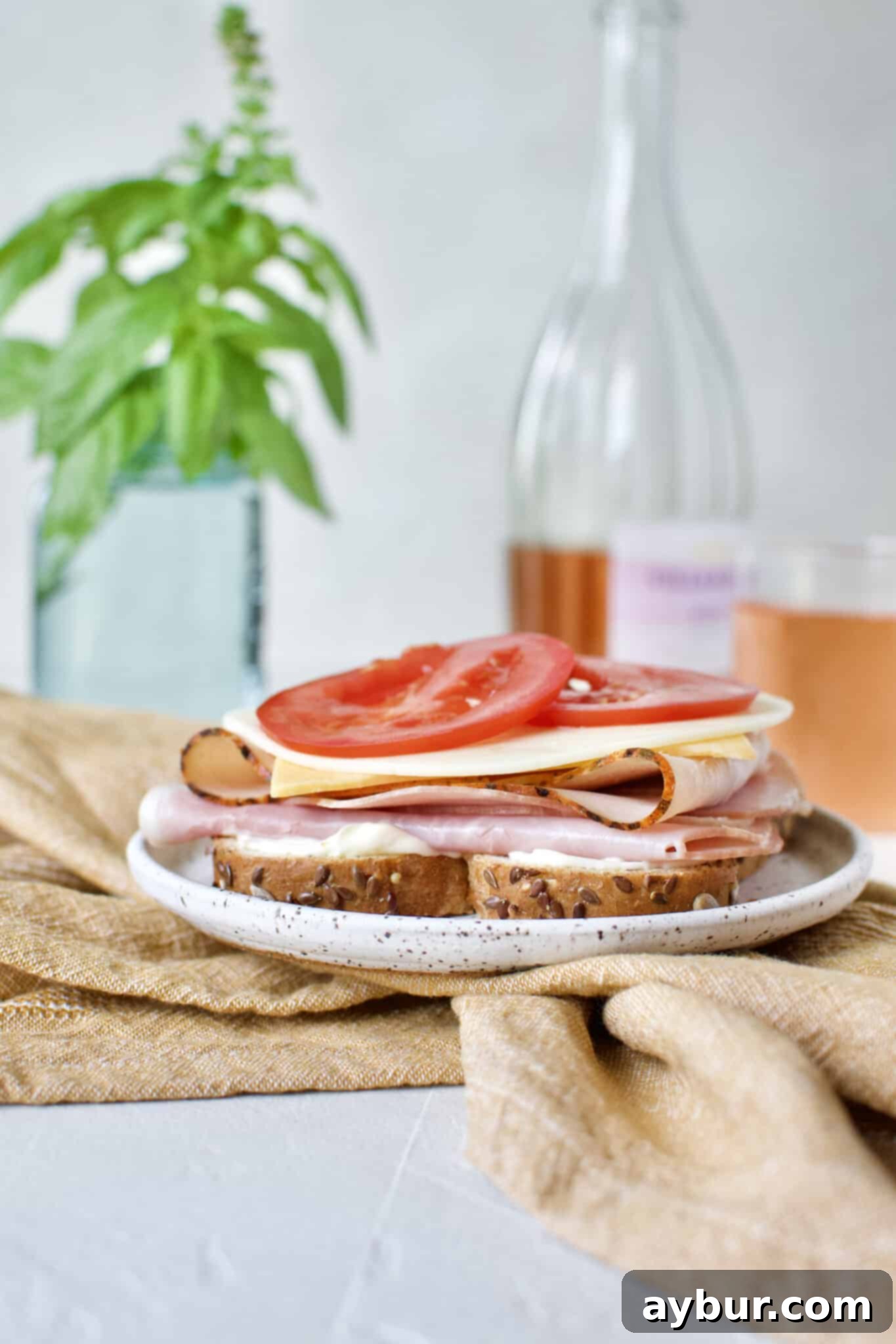Fresh, vibrant slices of vine-ripened tomato are now placed on the Club Sandwich, adding juiciness.