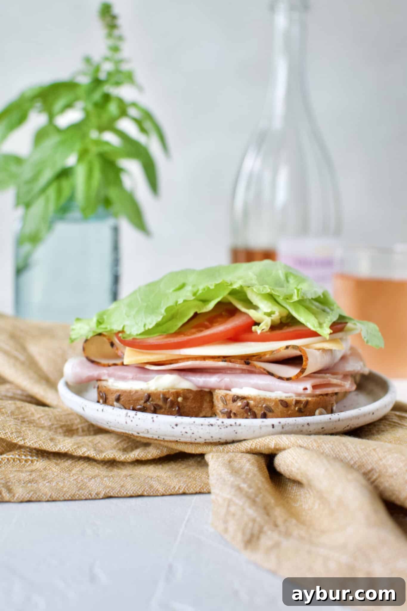 Crisp iceberg lettuce leaves are added to the Club Sandwich, providing a refreshing crunch to the layers.