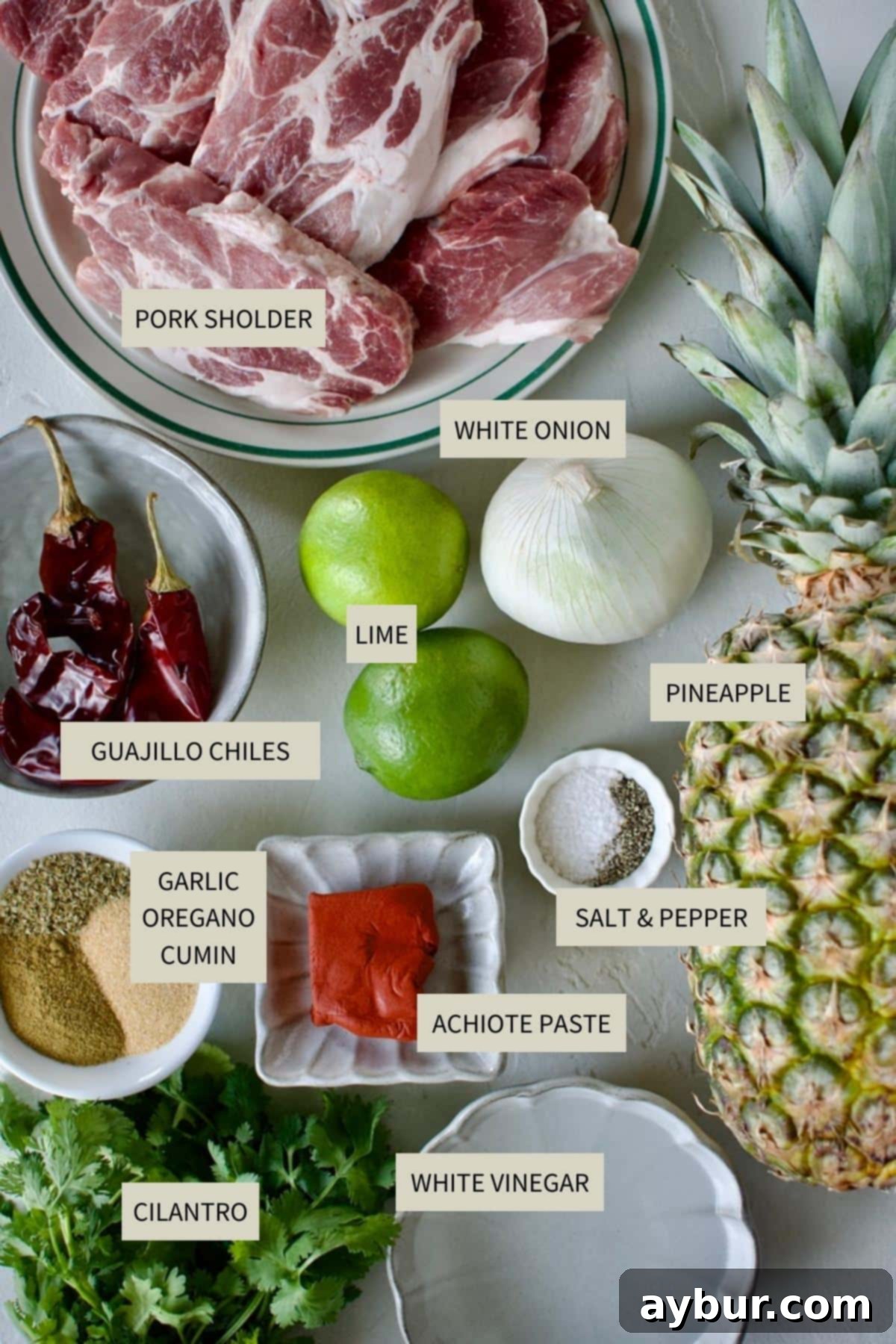Authentic Al Pastor Tacos 3 A selection of fresh ingredients required to prepare Al Pastor Tacos, including pork, pineapple, and various spices.